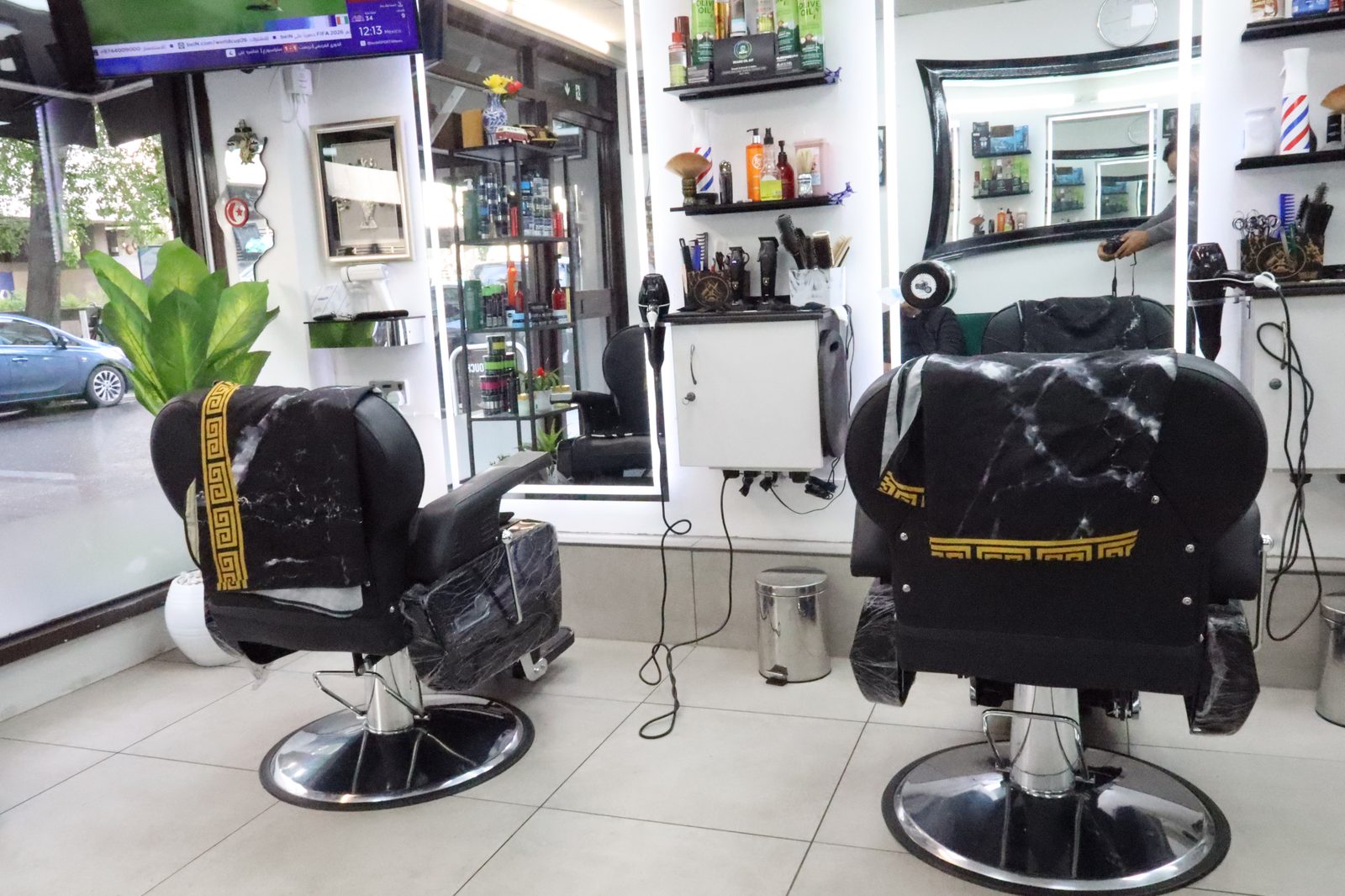 A morning on the shop floor — barbers working two chairs at Golden Touch
