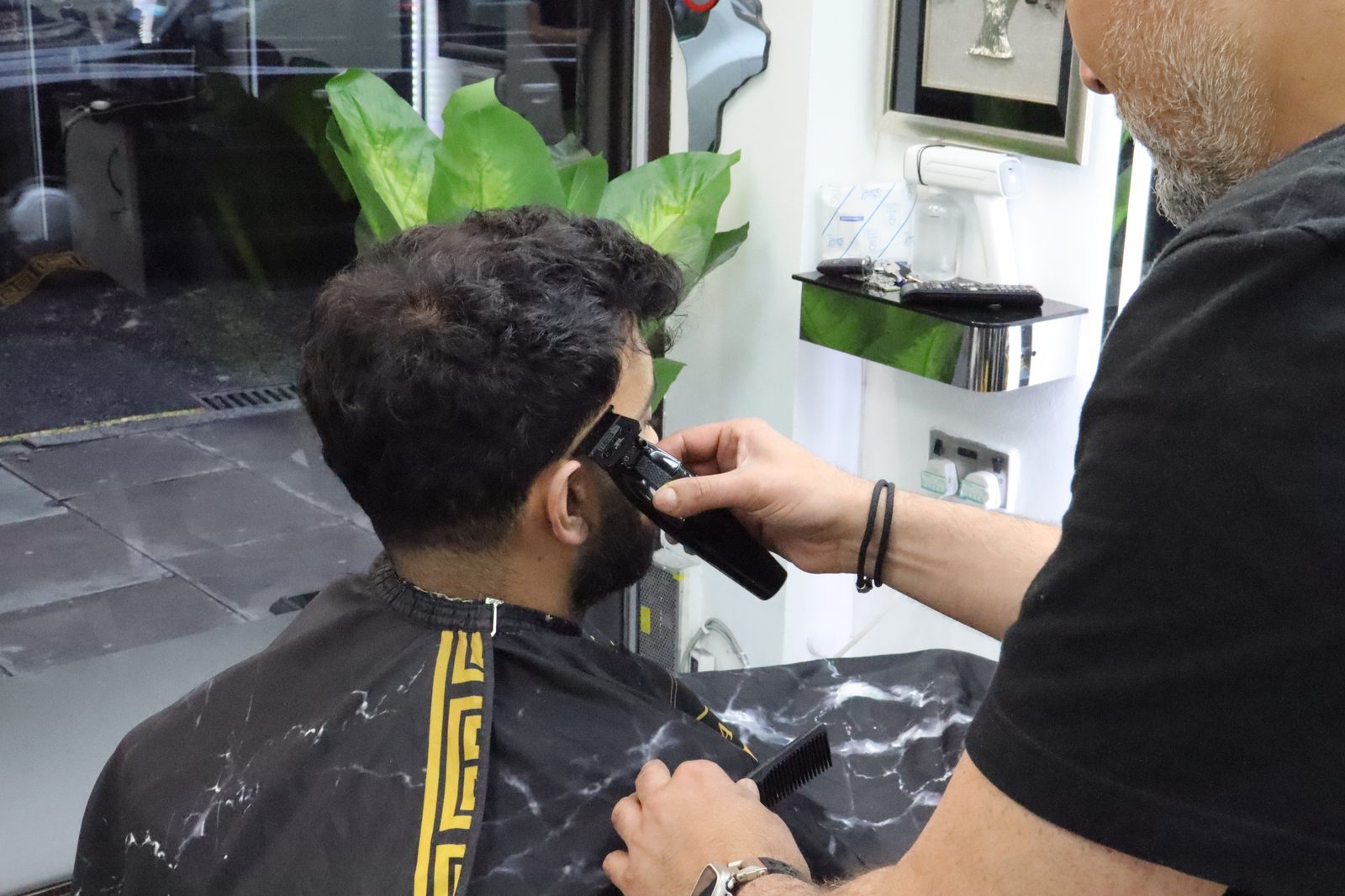 Skin fade in progress — clipper work around the ear